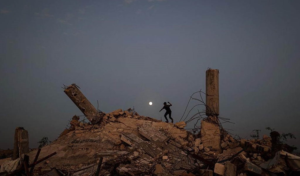 فتى فلسطيني يطارد القمر فوق أنقاض غزة